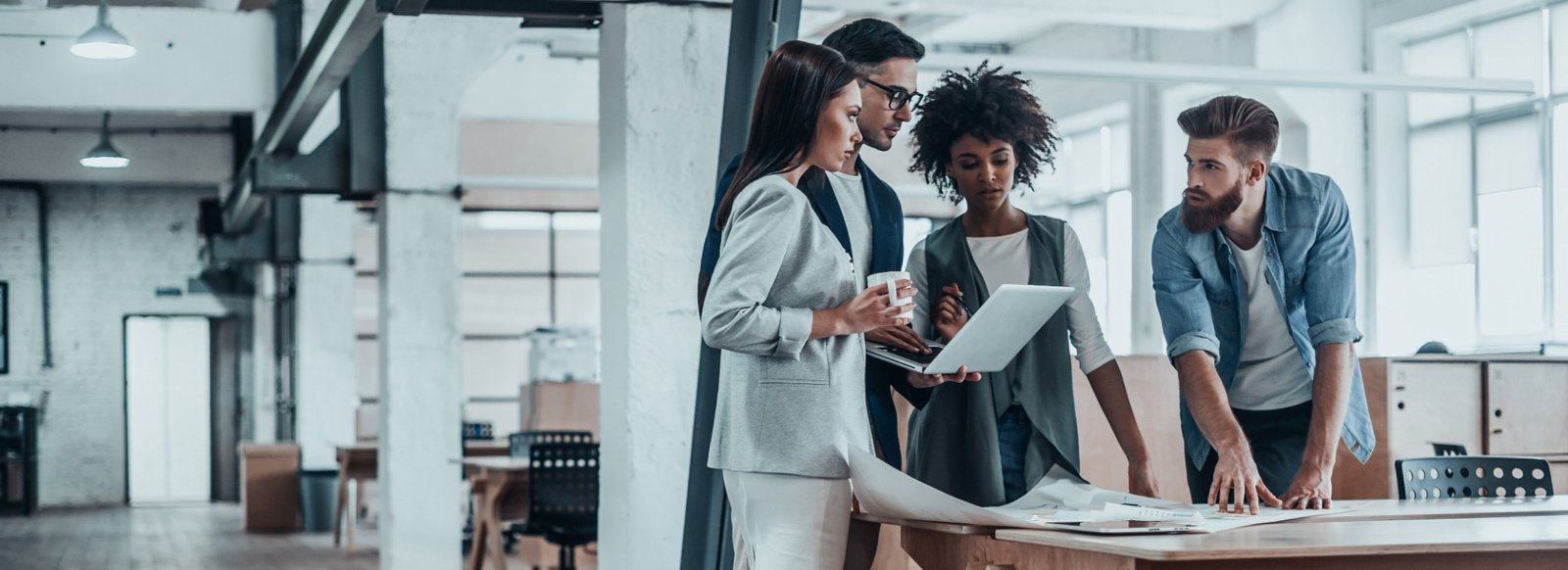 Team collaborating around plans in a modern workspace